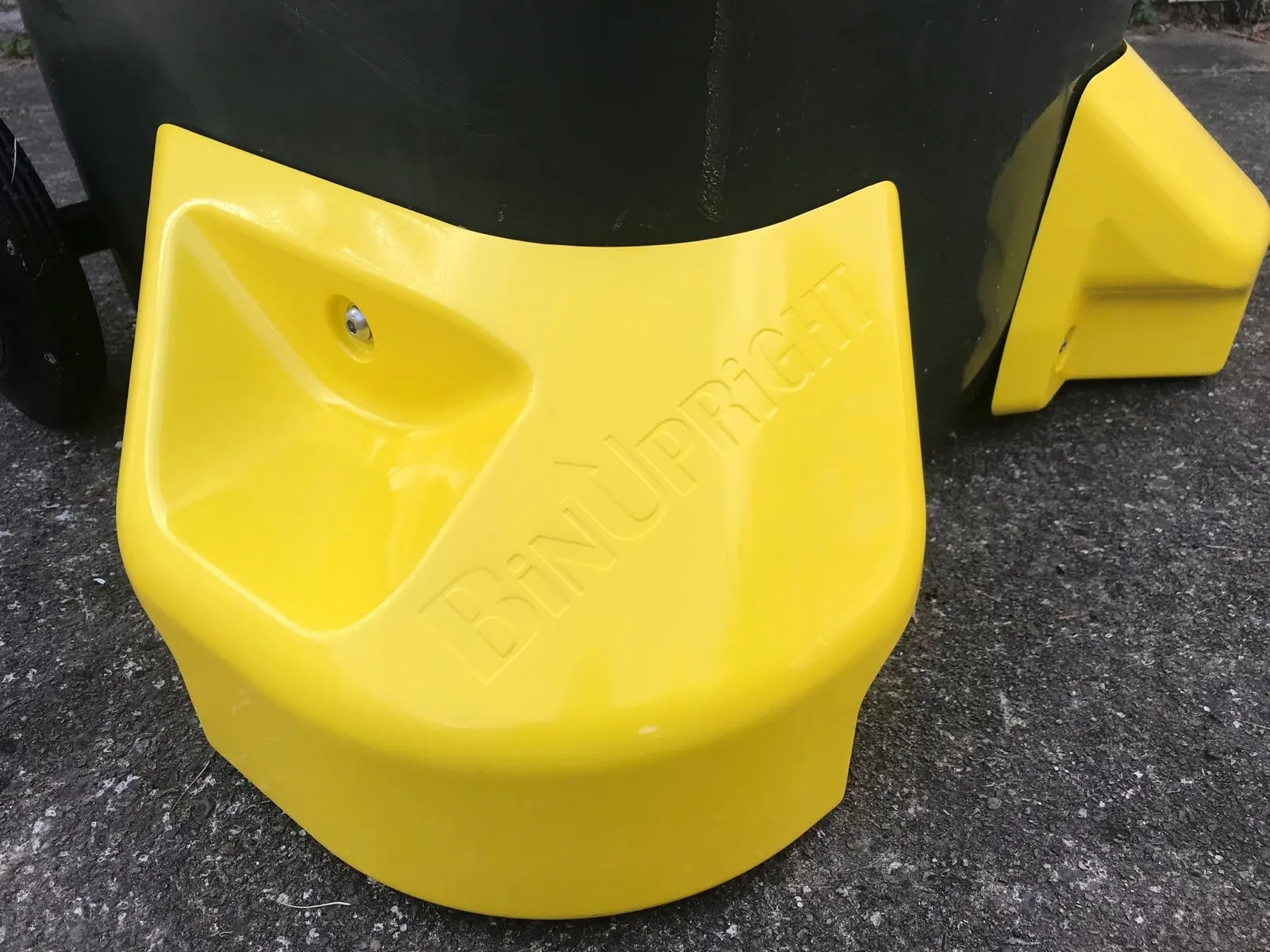 Close-up of yellow BinUpright stabiliser fitted to a wheelie bin